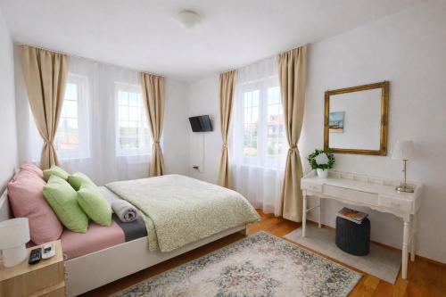 a bedroom with a bed with a mirror and a desk at Libás Apartman in Keszthely