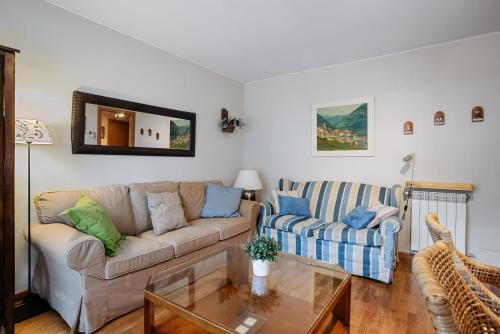 a living room with a couch and a table at Gaudioso by Cardi Suites in Sallent de Gállego