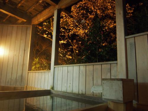 a porch with a bench and a window at night at Inn Yokotei in Nagatoro