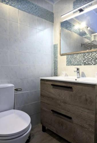 a bathroom with a toilet and a sink at Hôtel Archipel in Balaruc-les-Bains