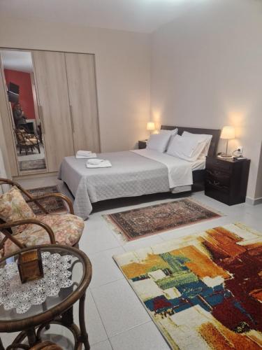 a hotel room with a bed and a chair at Ktima Lena in Órmos