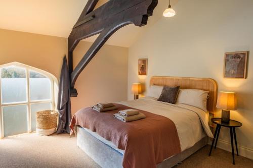 a bedroom with a large bed and a large window at Luxury Riverside Duplex Apartment for 4 in Wilton
