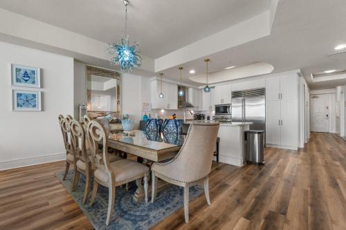 a dining room and kitchen with a table and chairs at Turquoise 1908C in Orange Beach