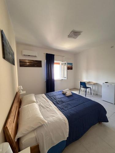 a bedroom with a large bed and a table at A Due Passi dal Centro in Favignana