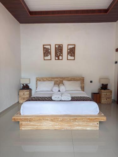 a bedroom with a bed with two towels on it at Villa Bianca Lovina by GEMA MANAGEMENT BALI in Lovina