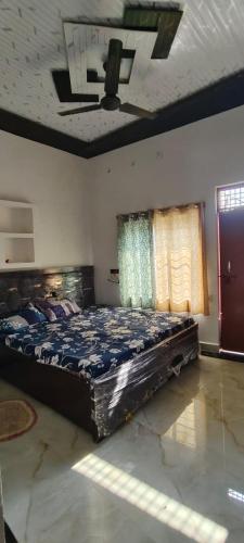 a bedroom with a large bed in a room at Thakur place in Mathura