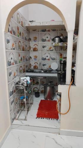 a kitchen with a counter with a red rug at Thakur place in Mathura