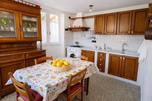 a kitchen with a table with a bowl of fruit on it at Casa Lapè in Levanto