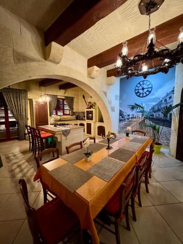 a large dining room with a table and chairs at Renovated Farmhouse with Heated Pool & Gym, right in Village Centre in Nadur