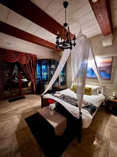a bedroom with a bed with a mosquito net at Renovated Farmhouse with Heated Pool & Gym, right in Village Centre in Nadur