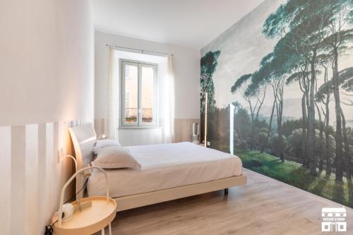 a bedroom with a bed with a large painting on the wall at SANTA MARTA by Design Studio in Bellano