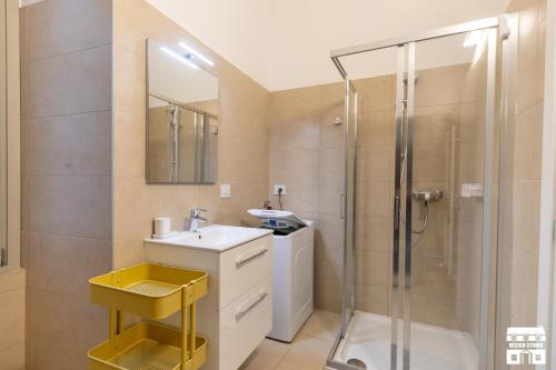 a bathroom with a sink and a shower at SANTA MARTA by Design Studio in Bellano