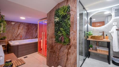 a bathroom with a wall with plants on it at Villa Vinea by Villas Guide in Novakovec