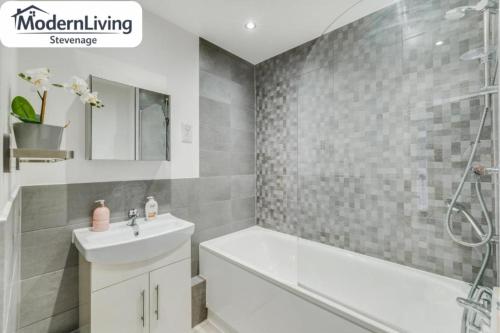 a bathroom with a sink and a tub and a shower at ModernLiving Stevenage 1 Bedroom Apartment Town Centre Sleeps 4 in Stevenage