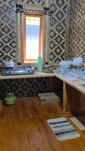 a kitchen with a counter with a window and a table at Villa zann kaktus in Nempel