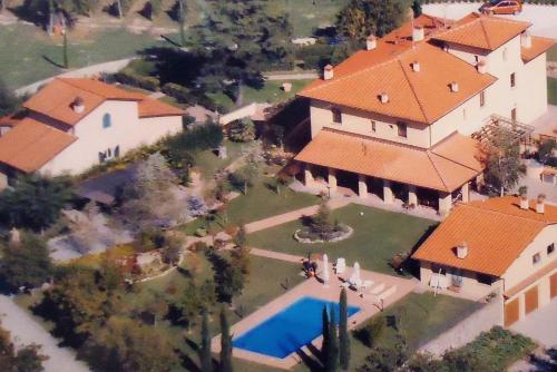 an overhead view of a large house with a swimming pool at Torrebianca Tuscany in Rignano sullʼArno