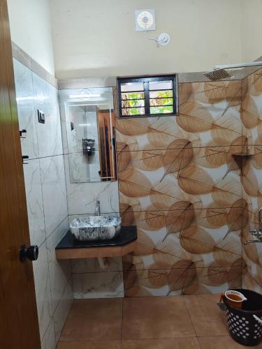 a bathroom with a sink and a mirror at Leaf Garden Retreat in Varkala
