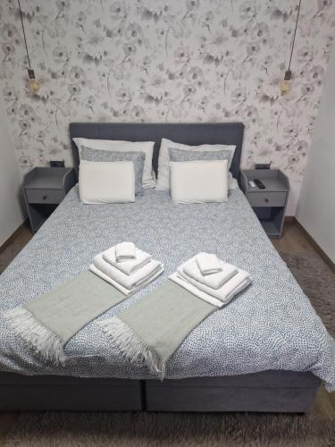 a bedroom with a bed with two towels on it at Modern 4 stars Apartment with terace & free parking in Šibenik