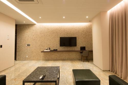 a hotel lobby with a tv on a wall at The Empress Hotel in Daejeon