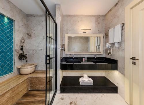 a bathroom with a glass shower and a sink at Marnas Hotels in Istanbul