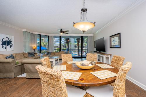 a dining room with a table and chairs at Phoenix on the Bay 1109 condo in Orange Beach