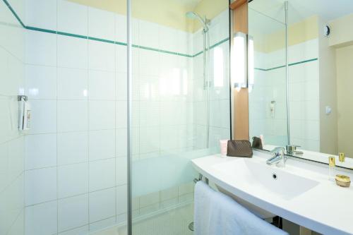 a bathroom with a sink and a shower at ibis Marseille Timone in Marseille