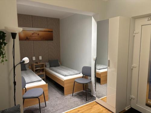 a hospital room with two beds and a table and chairs at Apartment in der Eifel in Blankenheim
