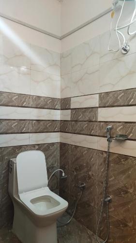 a bathroom with a toilet and a shower at Royal guest house in Gorakhpur