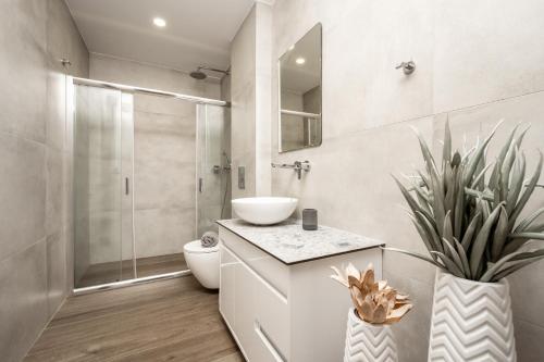 a bathroom with a sink and a toilet and a shower at Sinati Luxury Studios Laganas Zakynthos in Laganas