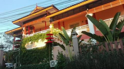 a house with a fence in front of it at Lampang Lanna Home in Lampang