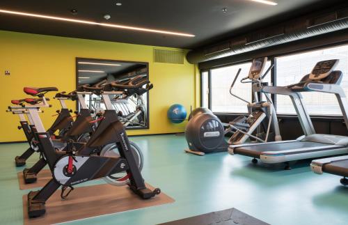 a gym with several tread machines in a room at Thon Hotel Oslo Airport in Gardermoen