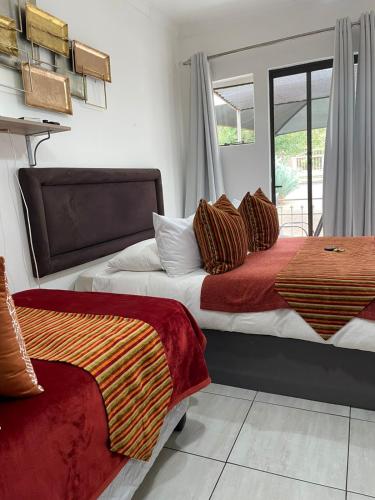 a bedroom with two beds and a window at Magalies B&B LANGENHOVENPARK in Universitas