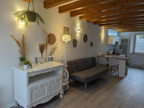a living room with a couch and a table at Cozy AM Spa and Cinema in Andance