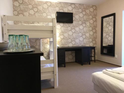 a bedroom with a bunk bed and a desk with a bunk bed at Penzion Fojtstvi in Olomouc
