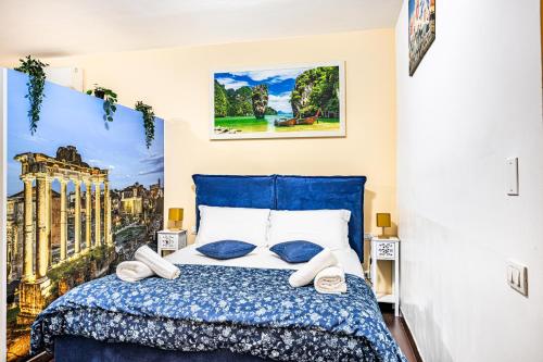 a bedroom with a blue bed with towels on it at Deluxe Apartments Pantheon in Rome