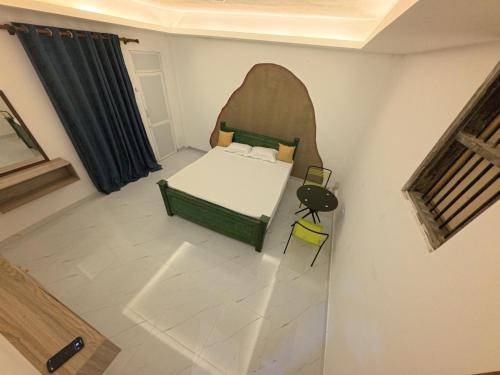 a small bedroom with a bed and a table at SeekRide Bolgoda in Bandaragama