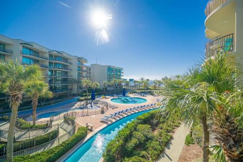 an aerial view of a resort with a pool and palm trees at Phoenix on the Bay 1211 condo in Orange Beach