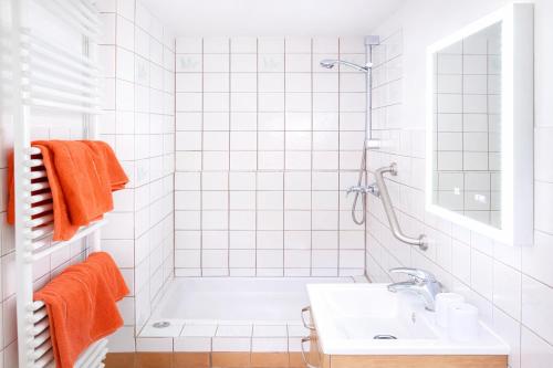 a white bathroom with a tub and a sink at Ferienwohnung Zur Rennsteigruh in Ruhla