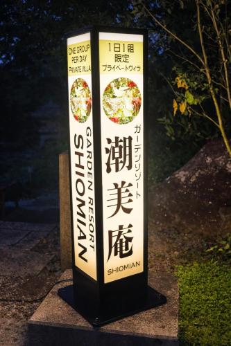 a sign for a restaurant with a pizza on it at ガーデンリゾート 潮美庵 in Hatsukaichi