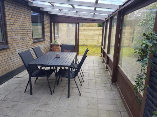 a patio with a table and chairs on a patio at Central Apartment in Billund - 500 m from LegoHouse in Billund