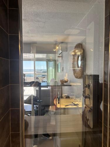 a kitchen with a view of a dining room at Sunset in Cap d'Agde