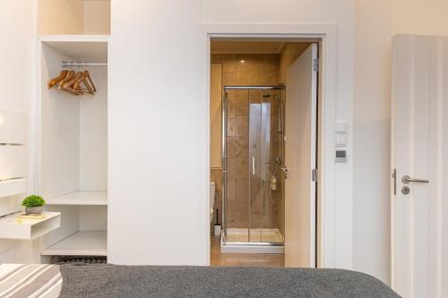 a bathroom with a shower with a glass door at Beach House Old Town in Cascais