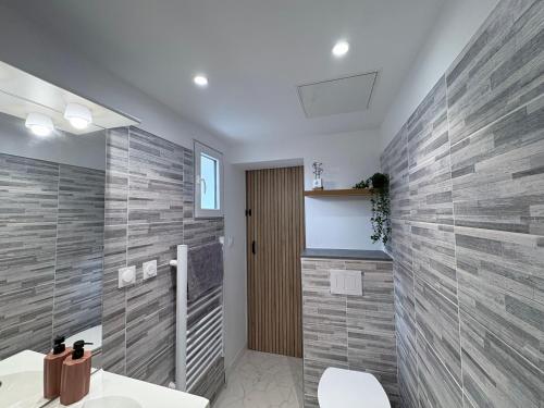 a bathroom with a shower and a toilet and a sink at Lodge La Forêt in Les Sables-d'Olonne