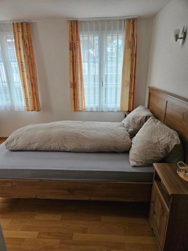 a bed sitting in a bedroom with a window at Hotel Sternen in Sisikon