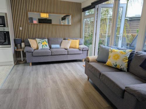a living room with two couches at Cabin 246 Riverside, Glan Gwna in Caeathro