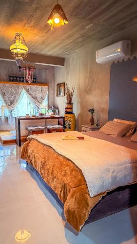 a bedroom with a large bed in a room at Vila Carmen Imperial in Domingos Martins
