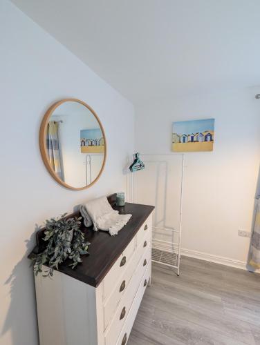 a dressing room with a mirror and a dresser at Cabin 246 Riverside, Glan Gwna in Caeathro