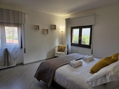 a bedroom with a large bed with two towels on it at Zenzero Comfort Apartment in Bellagio