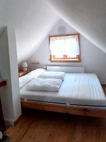 a bed in a room with a window at Ferienhaus Oppeln 21 in Wingst