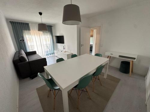 a living room with a white table and chairs at JP House in Figueira da Foz